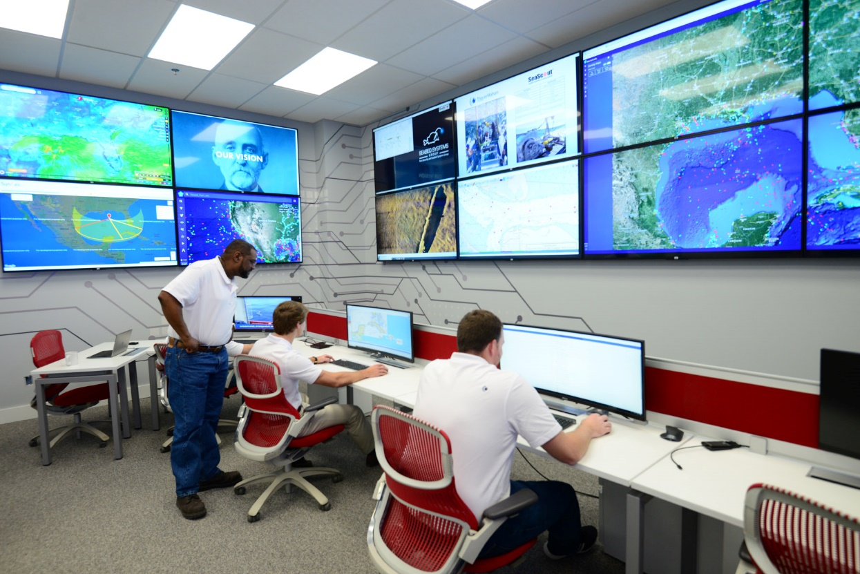 Former Navy NAV/ET Pedro Martinez supervises pilots and analysts in the new ThayerMahan Operations Center